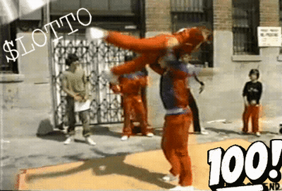 A Man In A Red Jumpsuit Is Doing A Trick In Front Of A Sign That Says $ Lotto GIF