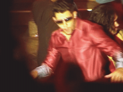 A Man In A Red Leather Jacket And Sunglasses Is Dancing GIF