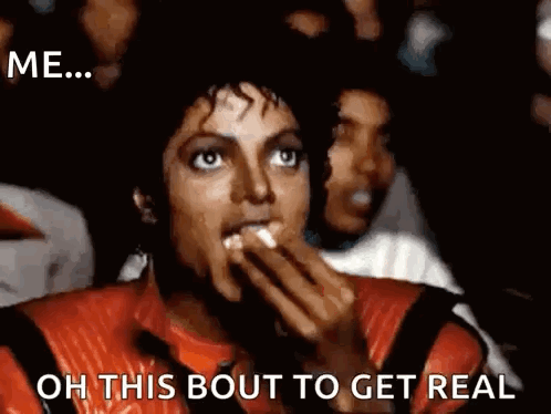 A Man In A Red Leather Jacket Is Eating Popcorn And Says Oh This Bout To Get Real GIF
