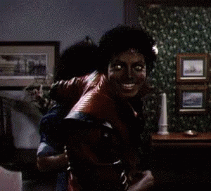 A Man In A Red Leather Jacket Is Holding Another Man On His Back GIF