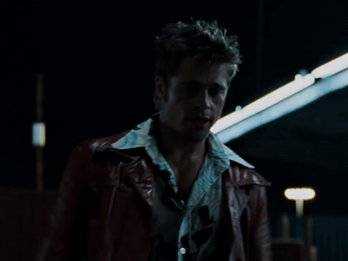 A Man In A Red Leather Jacket Stands In Front Of A Sign That Says " That 'S Right " GIF