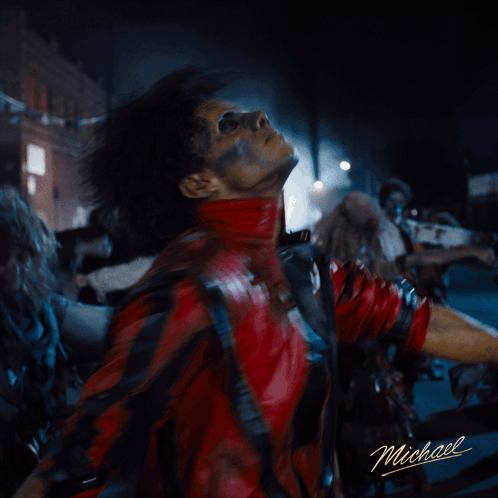 A Man In A Red Leather Jacket With Michael Written On The Bottom GIF