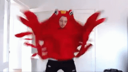 A Man In A Red Lobster Costume Is Dancing In A Living Room . GIF