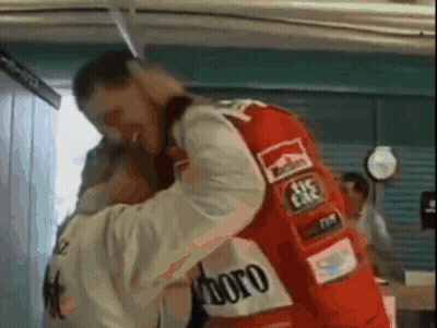 A Man In A Red Marlboro Jacket Is Hugging Another Man In A White Jacket . GIF
