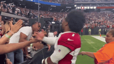 A Man In A Red Nike Jersey Is Being Lifted By A Crowd GIF