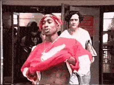 A Man In A Red Nike Shirt Is Standing In Front Of A Woman GIF