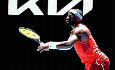 A Man In A Red Nike Tank Top And Headband Is Playing Tennis GIF