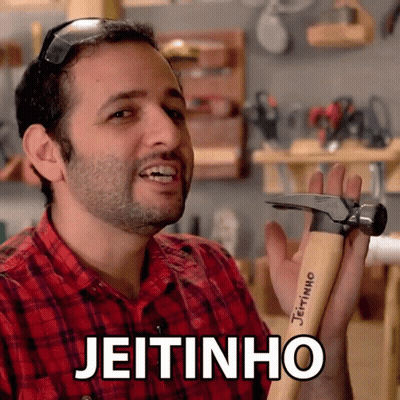 A Man In A Red Plaid Shirt Is Holding A Hammer With The Word Jeitinho Written On It GIF