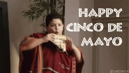 A Man In A Red Poncho Is Eating A Taco . GIF