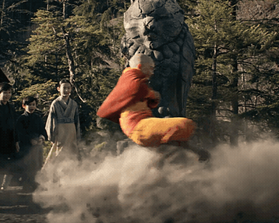 A Man In A Red Robe Is Flying Through The Air In Front Of A Statue GIF