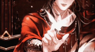 A Man In A Red Robe Is Holding A Small White Bird GIF