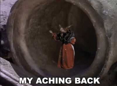 A Man In A Red Robe Is Standing In A Tunnel With The Words My Aching Back Below Him GIF