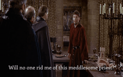 A Man In A Red Robe Stands In Front Of A Table With The Words Will No One Rid Me Of This Meddlesome Priest Below Him GIF