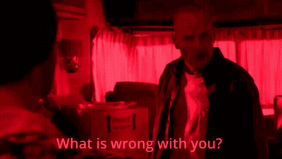 A Man In A Red Room With The Words " What Is Wrong With You " Below Him GIF