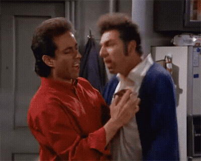 A Man In A Red Shirt And A Man In A Blue Cardigan Are Fighting GIF