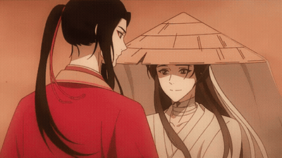 A Man In A Red Shirt And A Woman In A White Shirt Are Looking At Each Other GIF