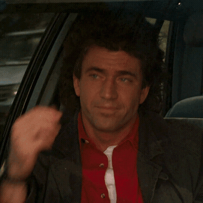 A Man In A Red Shirt And Black Jacket Is Sitting In The Back Seat Of A Car GIF