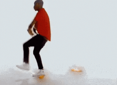 A Man In A Red Shirt And Black Pants Is Dancing In Front Of A Pile Of Fried Food . GIF