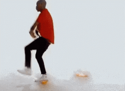 A Man In A Red Shirt And Black Pants Is Dancing On A White Background . GIF