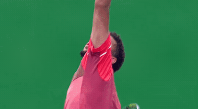 A Man In A Red Shirt And Shorts Is Playing Tennis GIF