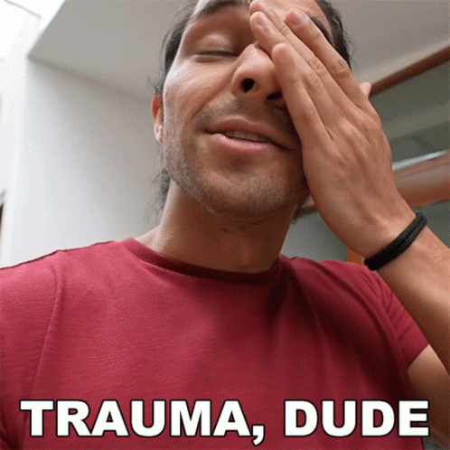 A Man In A Red Shirt Covering His Face With His Hands And The Words Trauma Dude Above Him GIF