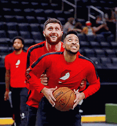 A Man In A Red Shirt Holding A Basketball That Says Dwight GIF