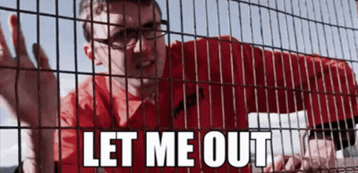 A Man In A Red Shirt Is Behind A Fence With The Words Let Me Out Written On It GIF
