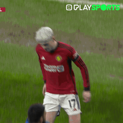 A Man In A Red Shirt Is Being Helped By A Man In A Yellow Jacket With Playsports Written In Green GIF