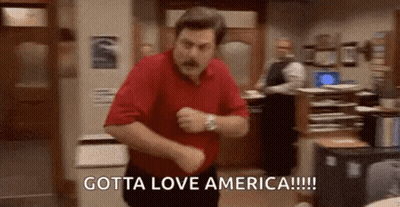 A Man In A Red Shirt Is Dancing In A Room With The Words `` Gotta Love America '' Written On The Bottom . GIF