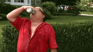 A Man In A Red Shirt Is Drinking From A Can Of Soda GIF