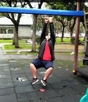 A Man In A Red Shirt Is Hanging From A Blue Rope GIF