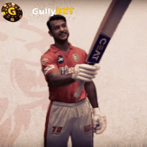 A Man In A Red Shirt Is Holding A Bat With A Ceat Logo On It GIF