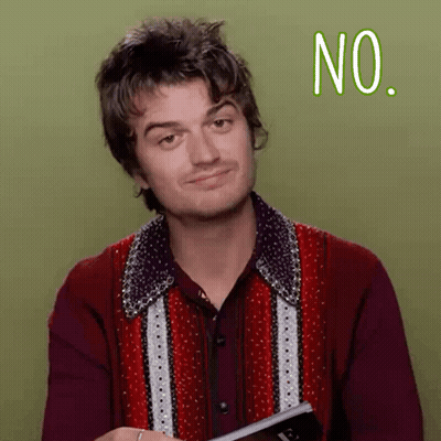 A Man In A Red Shirt Is Holding A Book And Making A No Sign GIF