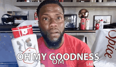 A Man In A Red Shirt Is Holding A Bottle Of Old Spice Deodorant GIF
