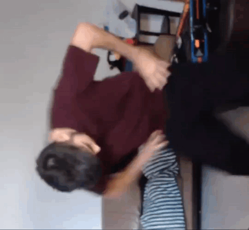 Man In Red Shirt Holding Child On Couch GIF