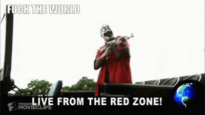 A Man In A Red Shirt Is Holding A Gun With The Words Fuck The World Live From The Red Zone GIF