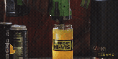 A Man In A Red Shirt Is Holding A Hammer In Front Of A Cabinet That Has The Word Tekam On It GIF