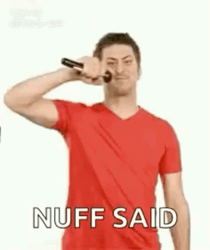 A Man In A Red Shirt Is Holding A Microphone In His Hand And Making A Funny Face . GIF
