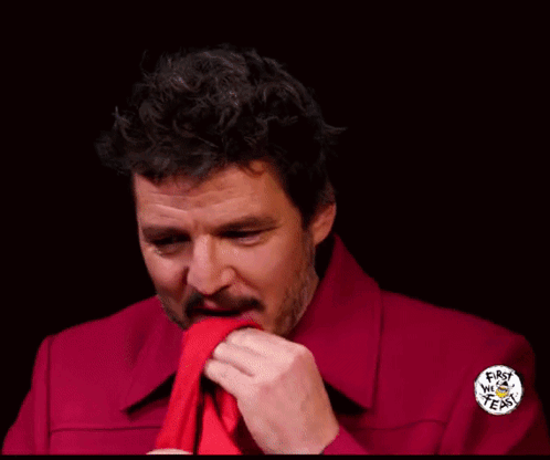 A Man In A Red Shirt Is Holding A Piece Of Paper With A Sticker On It That Says ' I Love You ' GIF