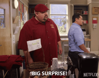 A Man In A Red Shirt Is Holding A Sign That Says Go Fund X GIF