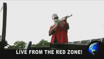 A Man In A Red Shirt Is Holding A Sword And The Words Fuck The World Live From The Red Zone GIF