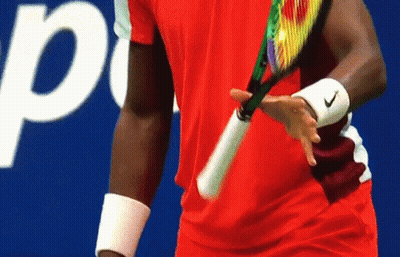 A Man In A Red Shirt Is Holding A Tennis Racquet In Front Of A Sign That Says Pepsi GIF