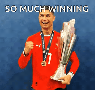 A Man In A Red Shirt Is Holding A Trophy With The Words So Much Winning Below Him GIF