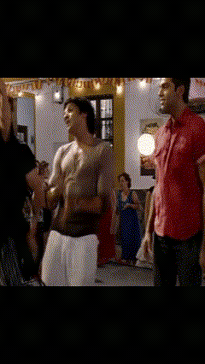 A Man In A Red Shirt Is Holding A Woman In A Room GIF