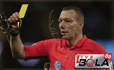A Man In A Red Shirt Is Holding A Yellow Card In Front Of A Banner That Says Live Bola GIF