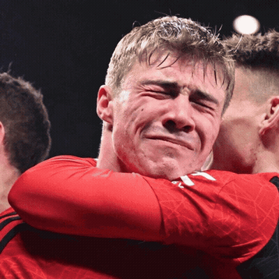 A Man In A Red Shirt Is Hugging Another Man Who Is Crying GIF