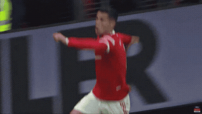A Man In A Red Shirt Is Jumping In The Air While Playing Soccer . GIF