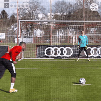 A Man In A Red Shirt Is Kicking A Soccer Ball GIF