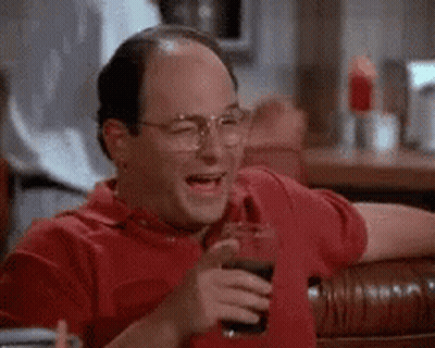A Man In A Red Shirt Is Laughing While Holding A Glass Of Coke . GIF