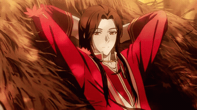 A Man In A Red Shirt Is Laying In The Grass With His Arms Outstretched GIF